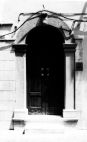 Fig. 24 Corso Giannone, 131. Portale ad arco a tutto sesto con stemma in chiave d'arco a forma di palma, con imposte dei piedritti a capitello e basi rimarcate. Particolare: Stemma in chiave d'arco a forma di palma con la punta ripiegata in avanti.